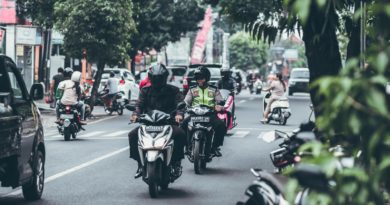 selective focus photography of people riding motorcycles on road