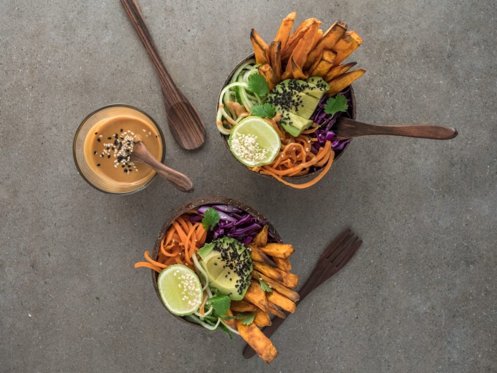 salad on brown wooden bowl with dip