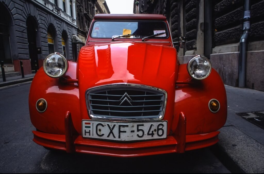 red Citroen car parked on road