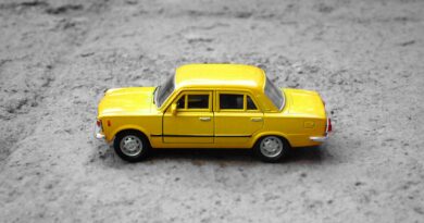 yellow sedan die-cast on gravel