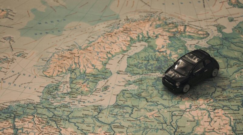A miniature black car on a detailed map of Scandinavia, symbolizing travel adventures.