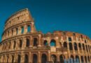 Stunning view of the ancient Roman Colosseum in Rome, Italy, captured at sunset showcasing its historic arches.