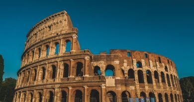 Stunning view of the ancient Roman Colosseum in Rome, Italy, captured at sunset showcasing its historic arches.