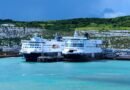 Ferry boats at Dover harbor with iconic white cliffs in the background. Captured on a sunny day in England.