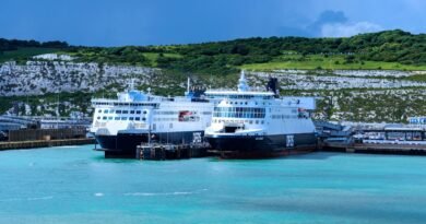 Ferry boats at Dover harbor with iconic white cliffs in the background. Captured on a sunny day in England.